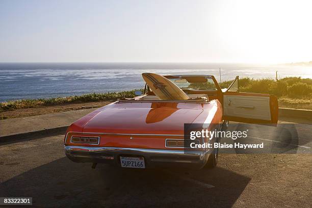 car with surfboard - vehicle door stock pictures, royalty-free photos & images