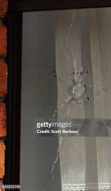 Bullet hole is seen in a window next to the front door after a drive-by shooting at a property in Narre Warren in Melbourne's south eastern suburbs...