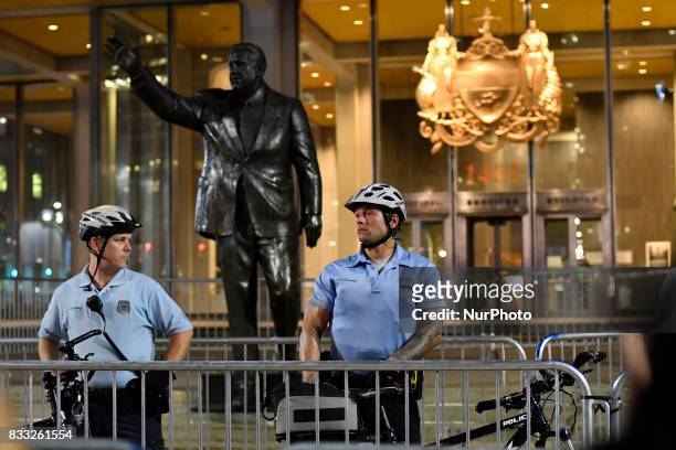 Police officers guard a statue of former Philadelphia mayor Frank Rizzo as protesters march against white supremacy August 16, 2017 in downtown...