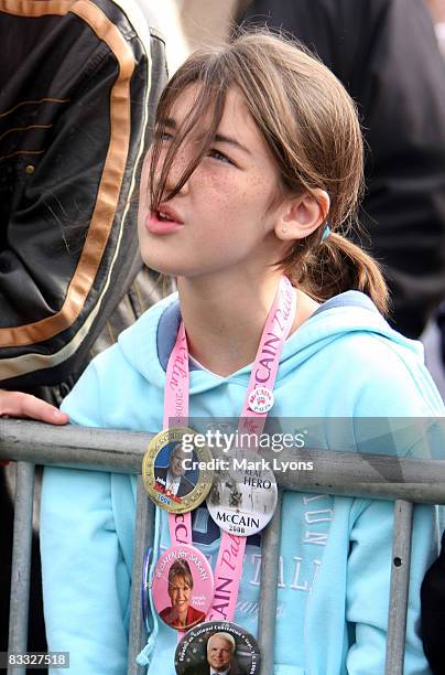 Child wearing campaign buttons listens to Republican vice presidential candidate Alaska Governor Sarah Palin speak during a campaign rally October...