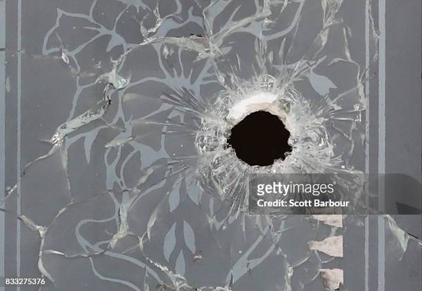 Bullet hole is seen in the glass of the front door after a drive-by shooting at a property in Narre Warren in Melbourne's south eastern suburbs on...