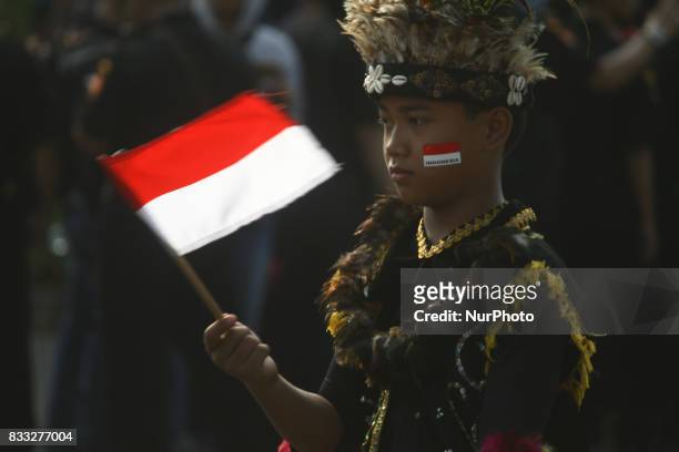 The marching band team from Indonesian military and police along with people with traditional dresses escorted the horse cart carriying the Bendera...