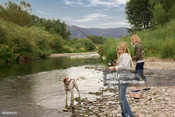 sisters fishing by river - bozeman stock pictures, royalty-free photos & images