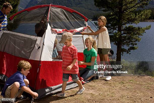 family setting up tent by lake - bozeman montana summer stock pictures, royalty-free photos & images