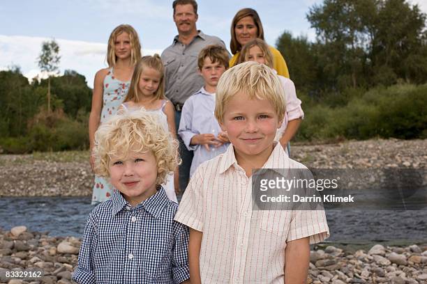 brothers standing in front of family - boy river looking at camera stock pictures, royalty-free photos & images