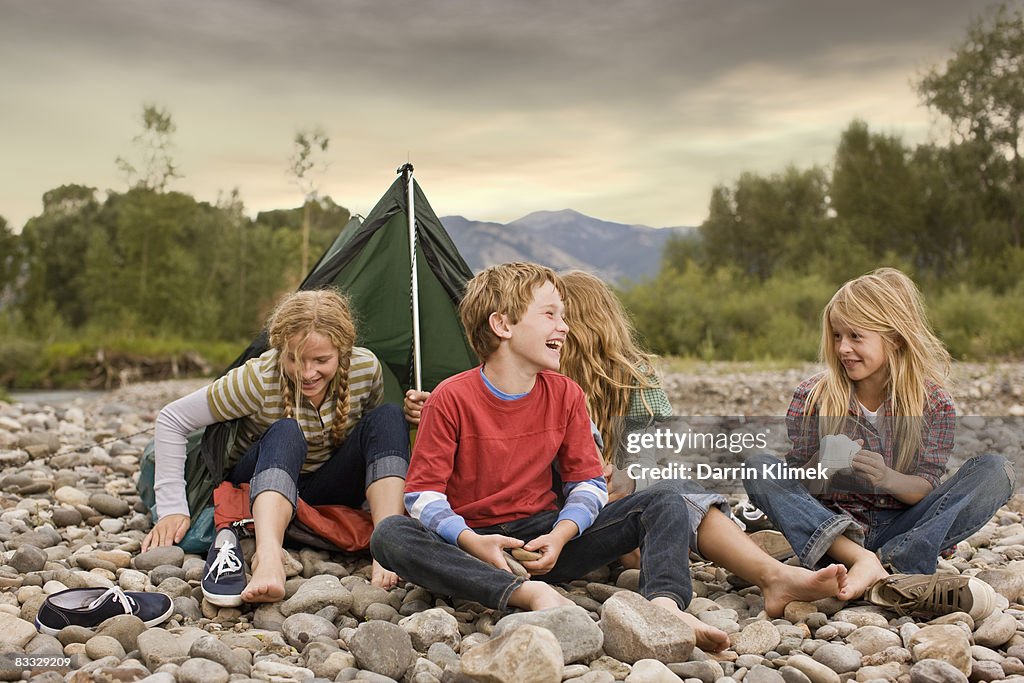 Brother and sisters playing in small tent