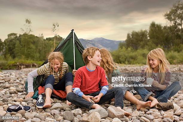 brother and sisters playing in small tent - blond boy stockfoto's en -beelden