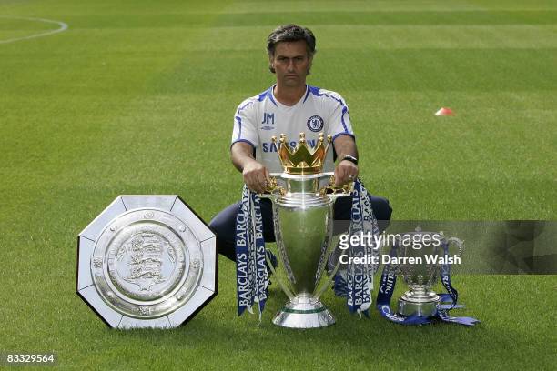 Jose Mourinho with the FA Community Shield, the Barclays Premiership Champions trophy and the Carling Cup at Chelsea FC's Pre-Season Open Day...