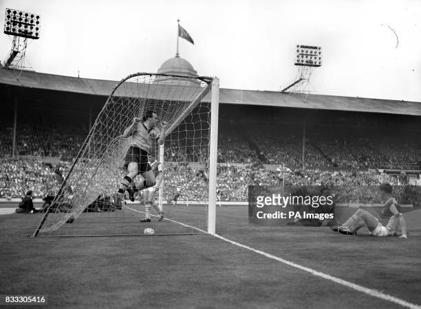 Wolverhampton's Norman Deeley hangs jubilantly on the netting as Blackburn's Michael McGrath scored an own goal.