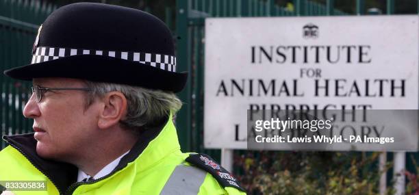 Police stand outside the Institute for Animal Health laboratory in Pirbright, Guildford, a suspected source of an outbreak of foot and mouth disease...