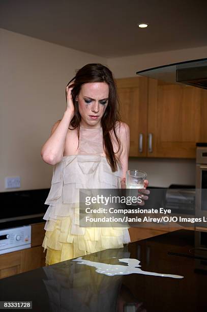 woman crying over spilt milk - spilt milk stock-fotos und bilder
