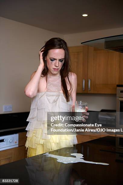 woman crying over spilt milk - spilt milk foto e immagini stock