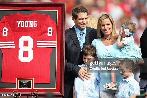 Former San Francisco 49ers quarterback Steve Young poses for picture with his family during a ceremony to retire his number at halftime of the New...
