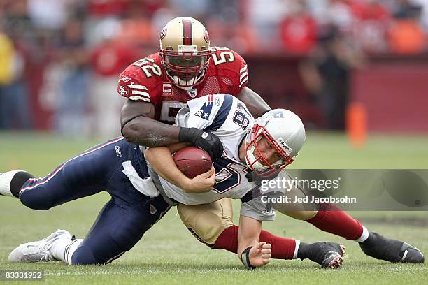 Quarterback Matt Cassel of the New England Patriots is sacked by Patrick Willis of the San Francisco 49ers during an NFL game on October 5, 2008 at...