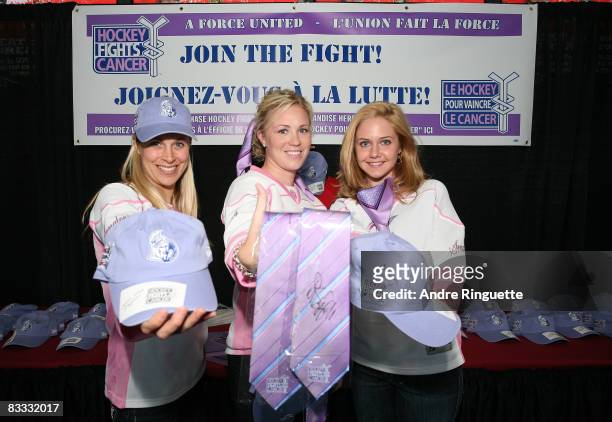 Ottawa Senators' wives and girlfriends Teresa Donovan, Caitlin Neil, Katie Perrault show off merchandise during Hockey Fights Cancer Awareness Night...