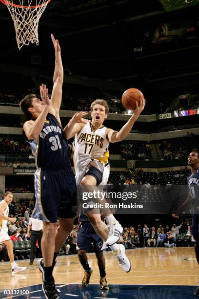 Mike Dunleavy of the Indiana Pacers drives to the basket past Darko Milicic of the Memphis Grizzlies at Conseco Fieldhouse on October 17, 2008 in...