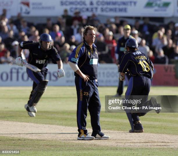 Hampshire's Shane Warne looks on as Sussex's Chris Adams and Andrew Hodd put on more runs during the NatWest Pro40 League Division One match at the...