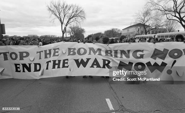 Washington, DC : Anti-Vietnam activists walk down the middle of the street in Washington, DC with a large anti-war banner on the day Richard Nixon is...