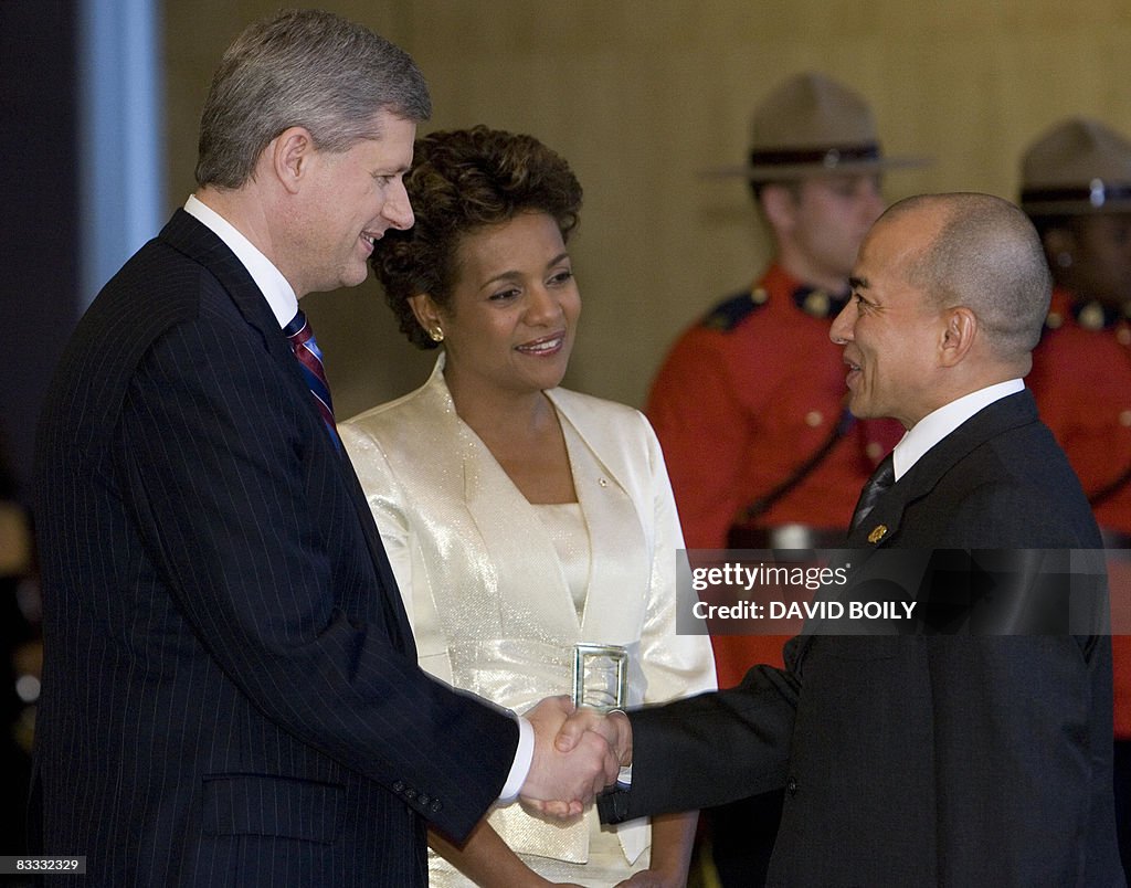 Cambodian King Sihamoni Norodom (R) is g