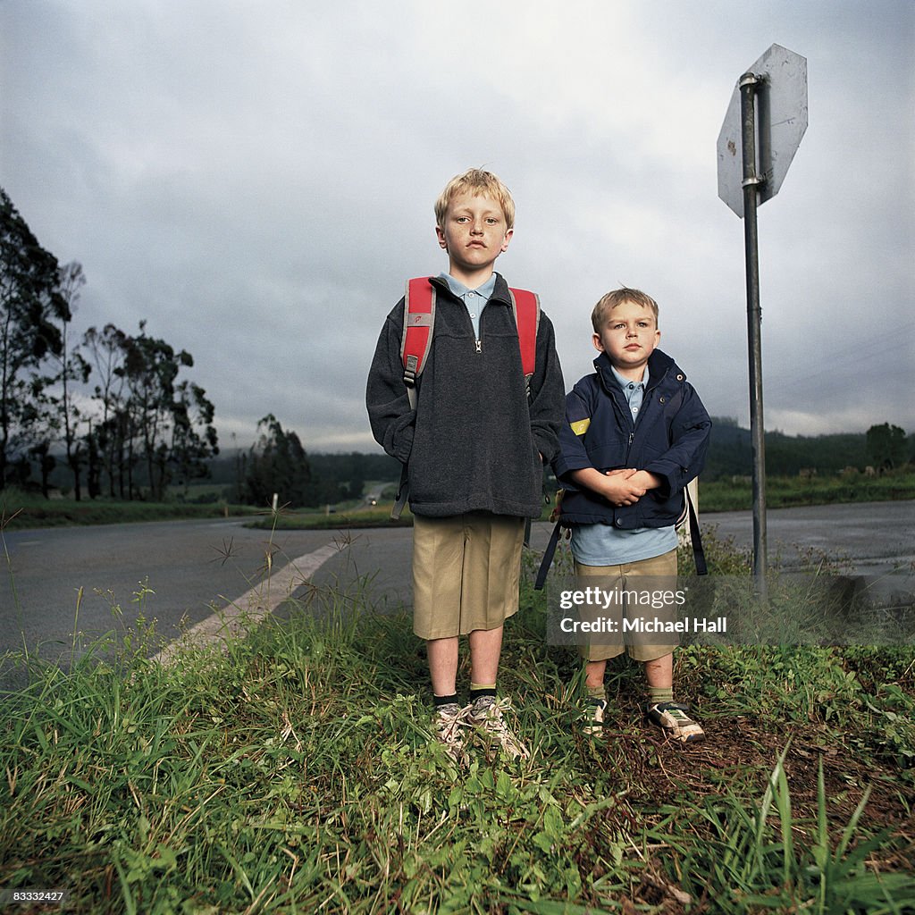 Boys waiting for country school bus