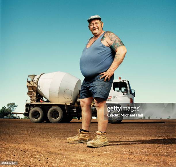 large man standing by cement truck - camiseta de tirantes fotografías e imágenes de stock