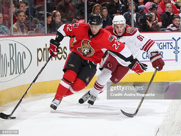 Chris Kelly of the Ottawa Senators stickhandles the puck against pressure from Kyle Turris of the Phoenix Coyotes at Scotiabank Place on October 17,...