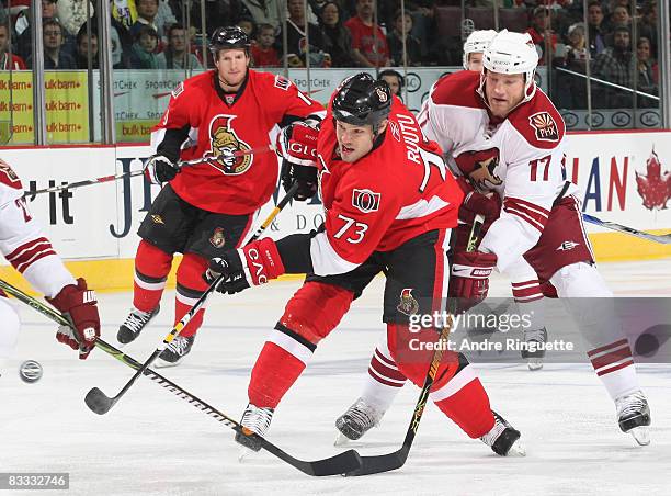 Jarkko Ruutu of the Ottawa Senators shoots the puck as Todd Fedoruk of the Phoenix Coyotes reaches to defend at Scotiabank Place on October 17, 2008...