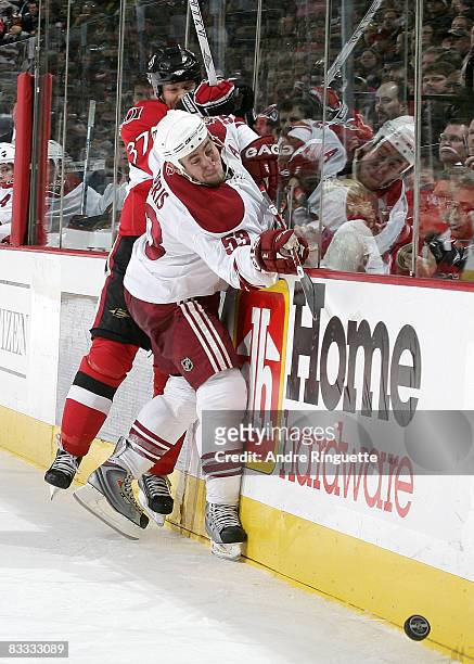 Dean McAmmond of the Ottawa Senators collides with Derek Morris of the Phoenix Coyotes along the boards at Scotiabank Place on October 17, 2008 in...
