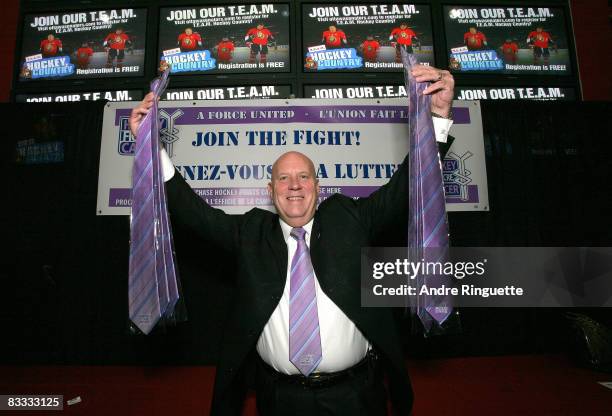 Ottawa Senators president Roy Mlakar shows off merchandise during Hockey Fights Cancer Awareness Night prior to a game against the Phoenix Coyotes at...