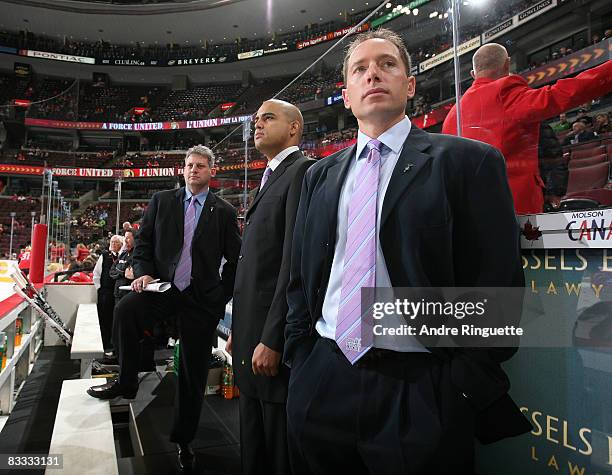 Ottawa Senators assistant coaches Curtis Hunt, Eli Wilson and Greg Carvel wear their Hockey Fights Cancer ties during warmups prior to a game against...