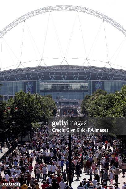 Fans make their way to Wembley Stadium before the Carnegie Challenge Cup Final at Wembley Stadium, London.