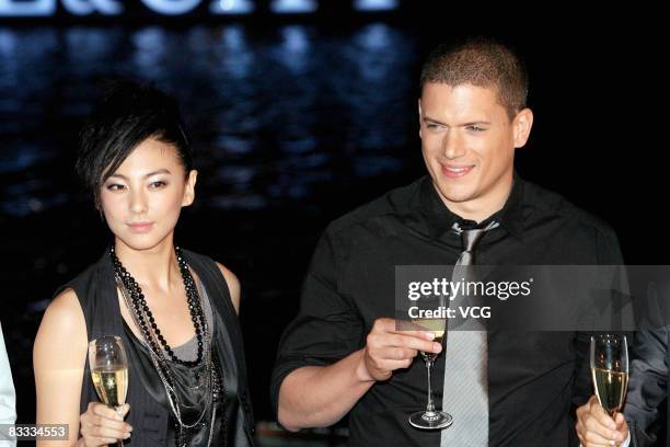 Actor Wentworth Miller from the television show 'Prison Break' poses with Chinese model Zhang Yuqi during a commercial activity for fashion brands on...