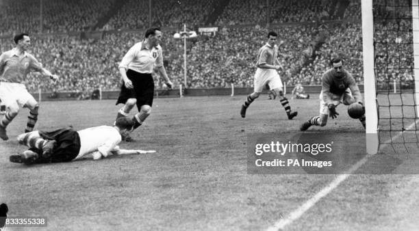 Arsenal goalkeeper George Swindin saves on the goal line after a shot from Liverpool's Jimmy Payne