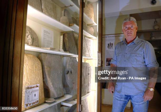 Medium and psychic Derek Acorah examines hieroglyphics on a stone tableau at the Petrie Museum of Egyptian Archaeology in central London.