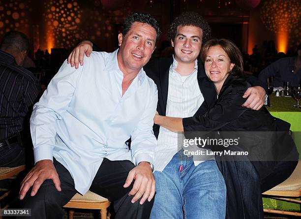 Former Miami Dolphin quaterback Dan Marino poses with his son Michael and wife Claire at the 8th Annual Bubbles and Bows Gala benefitting Here's Help...