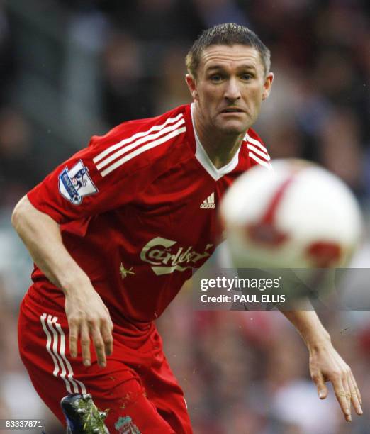 Liverpool's Irish forward Robbie Keane watches his shot go wide against Wigan Athletic during their English Premier League football match at Anfield...