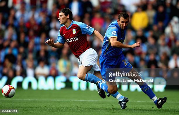Gareth Barry of Aston Villa wrong foots Glen Little of Portsmouth during the Barclays Premier League match between Aston Villa and Portsmouth at...