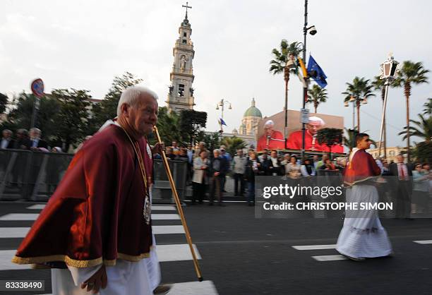 Peninents walk in procession past the Madonna Del Rosario Basilica, the Marian Shrine of Pompei on October 18, 2008 where Pope Benedict XVI will...