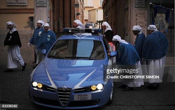 Peninents ask their way to policemen after a procession in the streets of Pompei on October 18 on the eve of the visit by Pope Benedict XVI. The Pope...