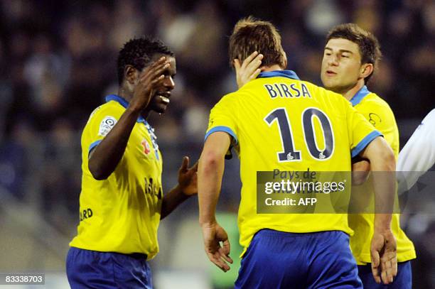 Sochaux's Slovenian forward Valter Birsa is congratulated by his teammates, Cameroonian midfielder Valery Mezague and Slovenian defender Bojan Jokic...