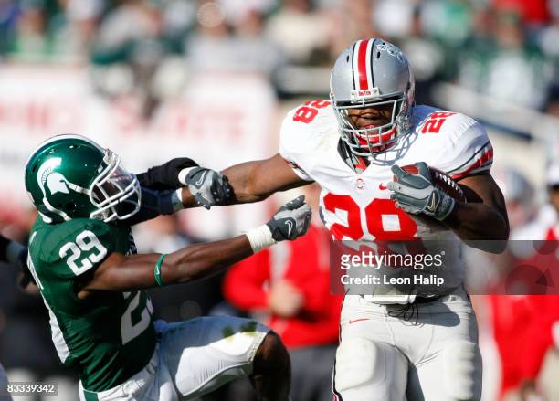 Chris Wells of the Ohio State Buckeyes stiff arms and runs for a first down against Chris Rucker of the Michigan State SPartans on October 18, 2008...