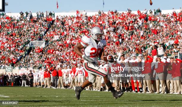 Chris Wells of the Ohio State Buckeyes scores a second quarter touchdown against the Michigan State Spartans on October 18, 2008 at Spartan Stadium...