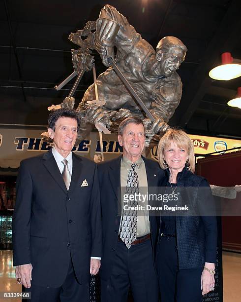 Detroit Red Wing Hall of Famer, Ted Lindsay poses for the media with Mike and Marian Ilitch, owners of the team, after the unvailing of the statue in...