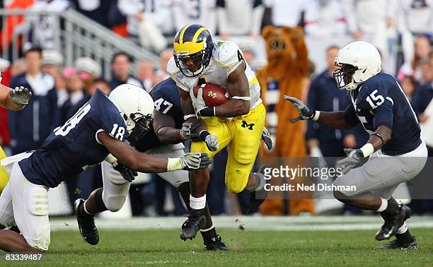 Running back Brandon Minor of the University of Michigan Wolverines runs against Navorro Bowman of the Penn State Nittany Lions at Beaver Stadium on...