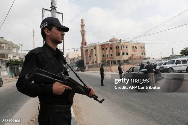Palestinian members of Hamas security forces stop a vehicle at a security checkpoint in Rafah in the southern Gaza Strip on August 17, 2017. A...