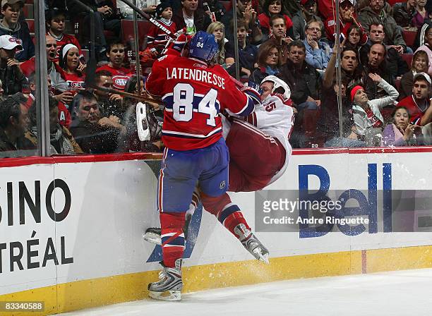 Guillaume Latendresse of the Montreal Canadiens bodychecks Ed Jovanovski of the Phoenix Coyotes into the end boards and off his feet in third period...