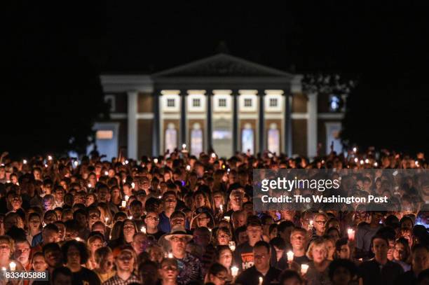 Hundreds of people march peacefully with lit candles across the University of Virginia campus on Wednesday, August 116 in Charlottesville, VA, in the...