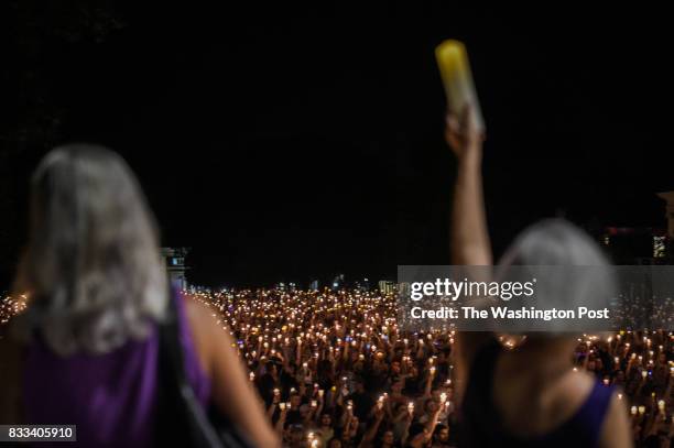Hundreds of people march peacefully with lit candles across the University of Virginia campus on Wednesday, August 116 in Charlottesville, VA, in the...