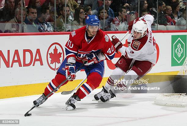 Maxim Lapierre of the Montreal Canadiens stickhandles the puck against Keith Yandle of the Phoenix Coyotes at the Bell Centre on October 18, 2008 in...