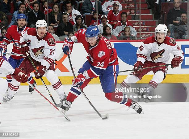 Sergei Kostitsyn of the Montreal Canadiens bends his stick on a wristshot as David Hale and Peter Mueller of the Phoenix Coyotes look on at the Bell...